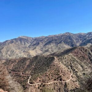 Group of motorcycles riding a quiet mountain road in Morocco